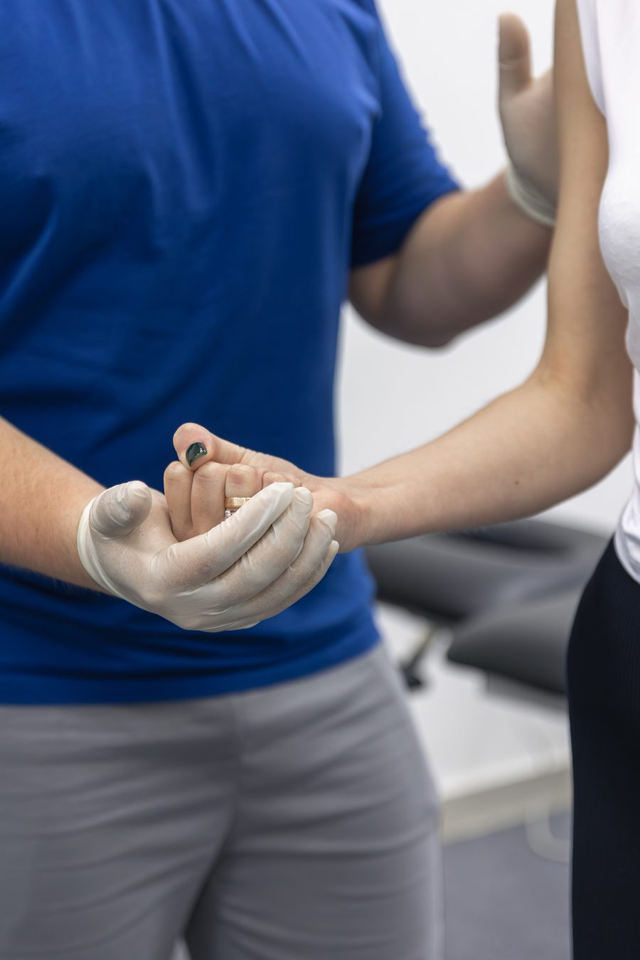 Physiotherapist performing a hands-on assessment with a patient